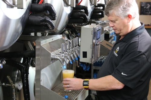 Ole pouring beer from Serving Beer Tanks